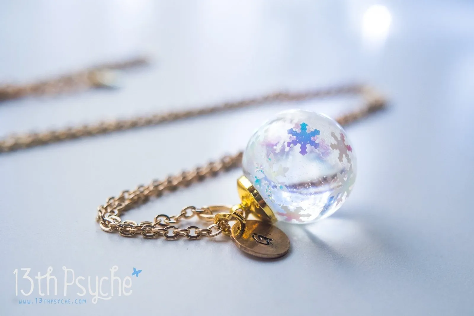 Winter inspired snowflake resin ball necklace